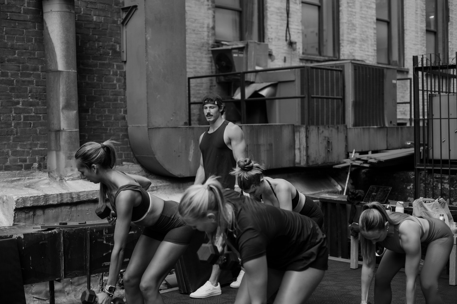 Group dumbbell workout on rooftop