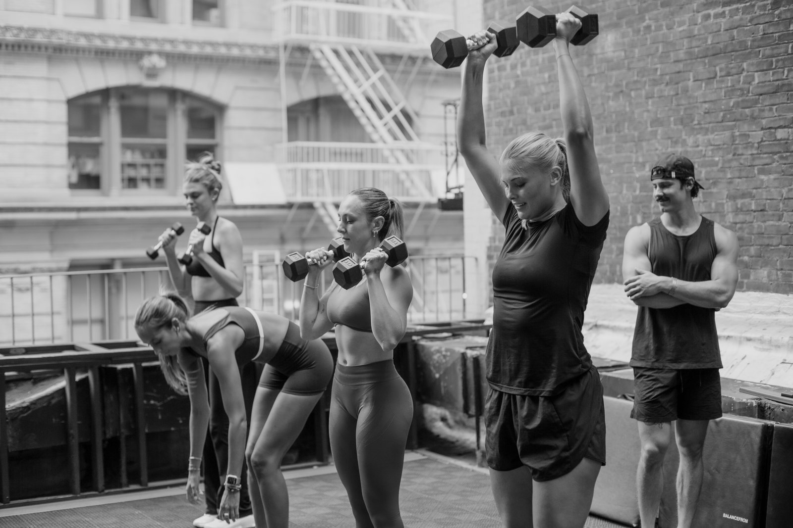 Group overhead press with dumbbells